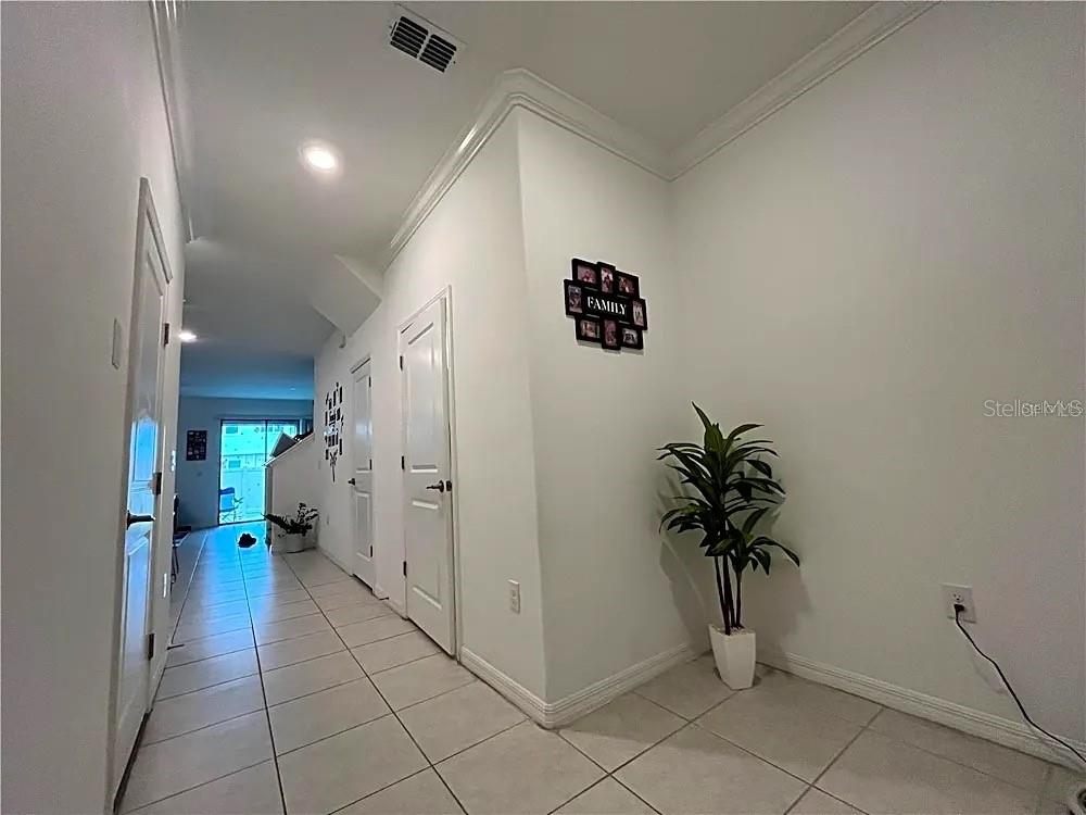 31751 Blue Passing Loop Wesley Chapel, FL 33545 - Photo 2 of 18 a view of hallway with paintings on the wall