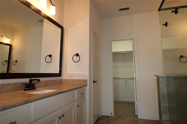 a bathroom with a sink and mirror
