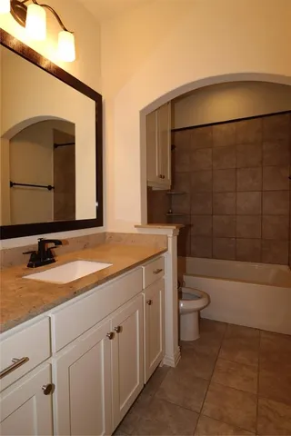 a bathroom with a toilet a sink and bathtub