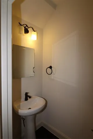 a bathroom with a sink and mirror