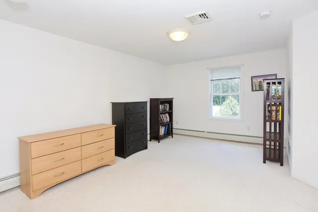 a view of an empty room with closet and cabinet