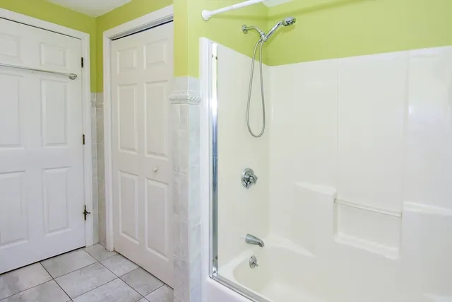 a bathroom with a shower and a glass door