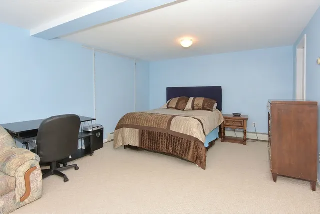 a bedroom with a bed and a chair