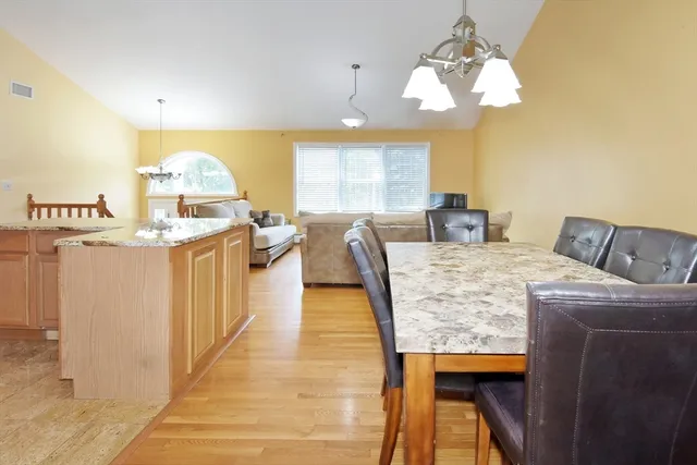 a view of a dining room with furniture and a chandelier