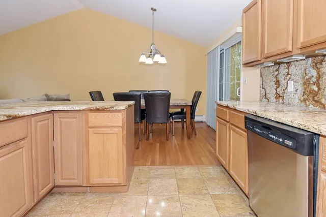 a view of a dining room with furniture and chandelier