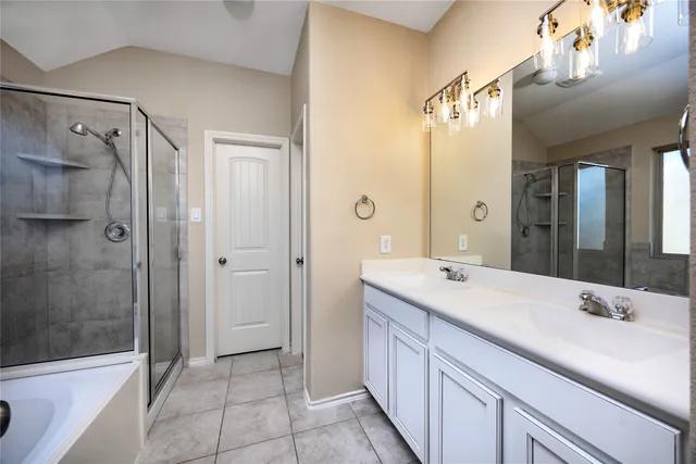 a bathroom with a shower sink and mirror