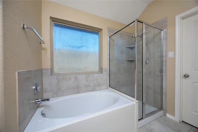 a white bath tub sitting next to a shower