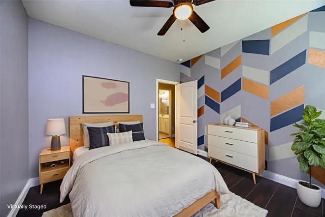 a bedroom with a bed and a potted plant