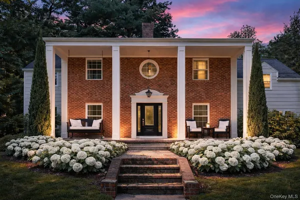 a front view of a house with garden