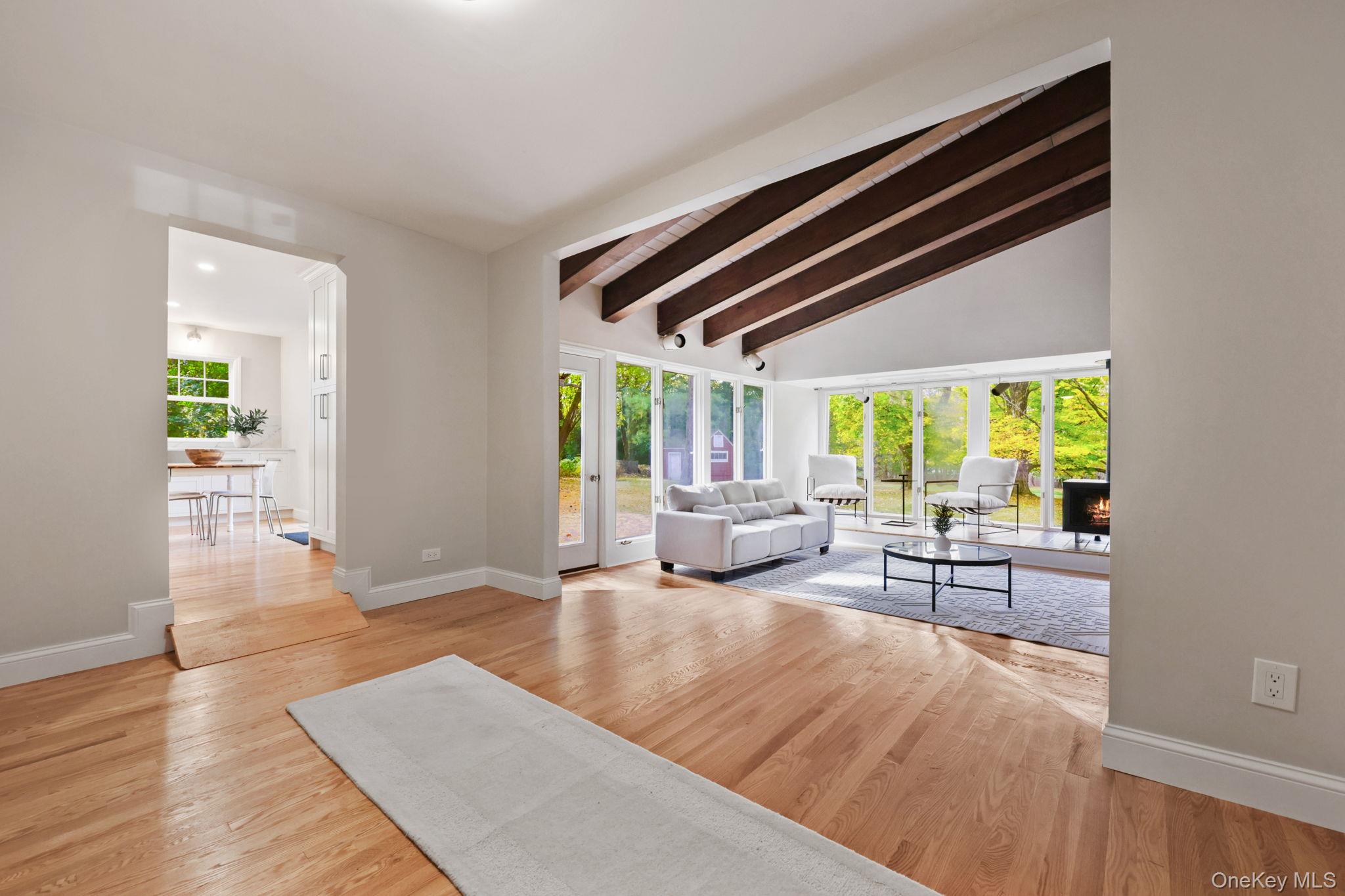 790 Hardscrabble Road Chappaqua, NY 10514 - Photo 18 of 40 Living area with light wood-style flooring and a lit fireplace