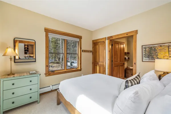 a bedroom with a bed and a dresser in it