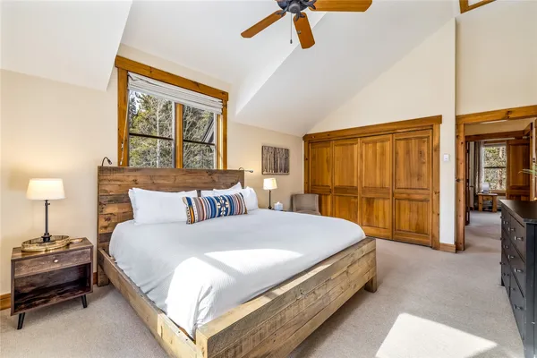 a spacious bedroom with a bed and wooden floor