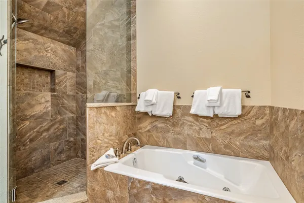 a bathroom with a bathtub and shower