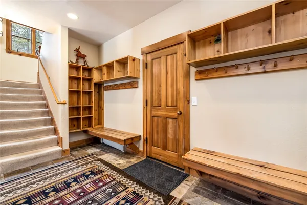 a view of front door with wooden floor and a rug