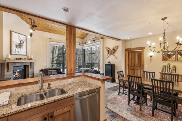 a view of a kitchen with granite countertop a table and chairs