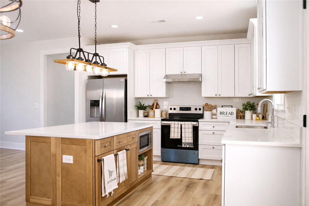 2515 Highway 29 Anderson, SC 29621 - Photo 10 of 38 Bright, open-concept kitchen features a spacious island and gleaming stainless steel appliances.