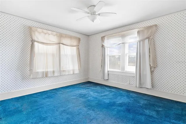 a view of a hallway to closet and utility room