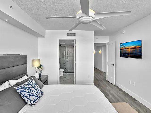 a bedroom with a bed and a chandelier