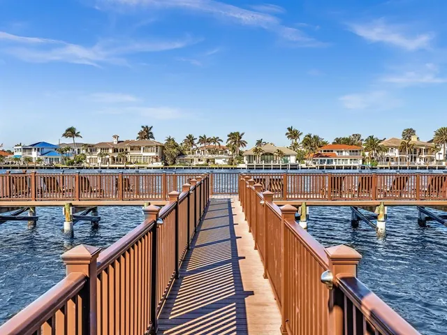 a view of a balcony with wooden floor and fence