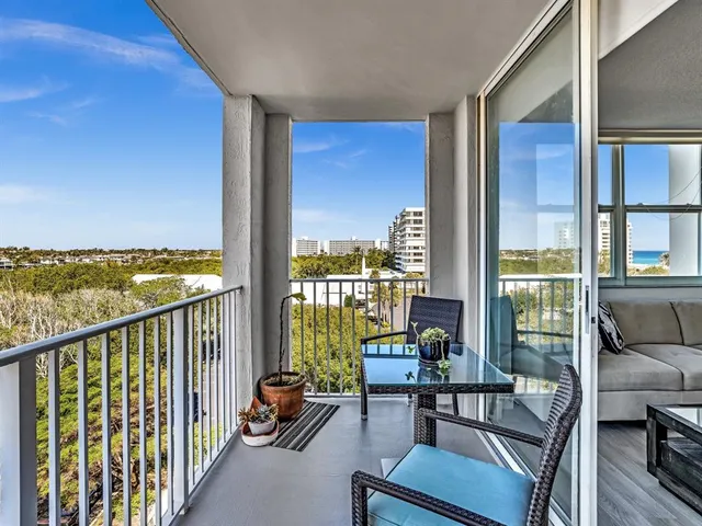 a balcony with chairs and wooden floor