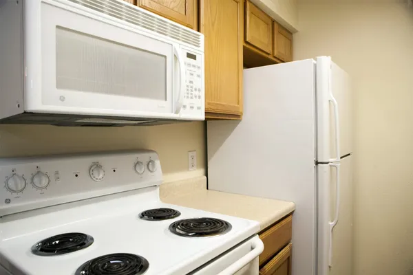 a view of an empty room with wooden floor and closet