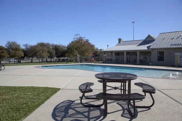 a swimming pool with outdoor seating and yard