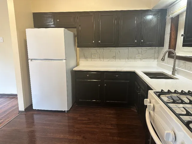 a kitchen with a sink a stove and refrigerator