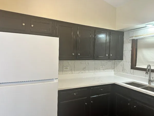 a kitchen with a sink and cabinets