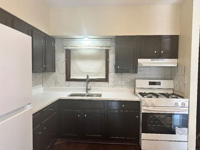 a kitchen with a sink stove and cabinets