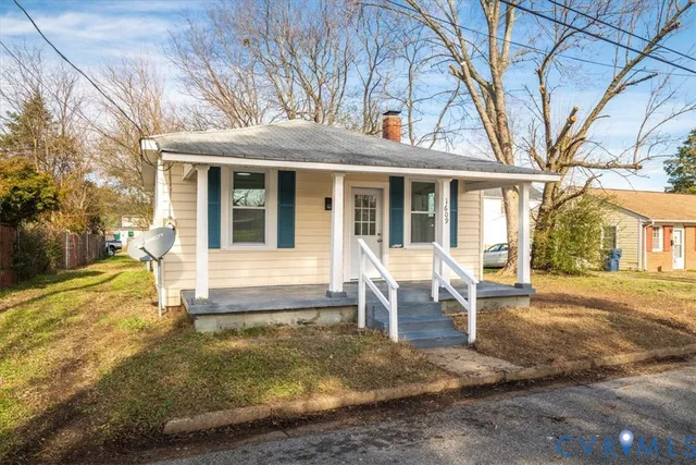 a view of a house with backyard porch and sitting area