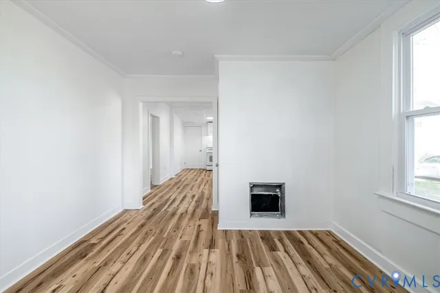 a view of a room with wooden floor and a window