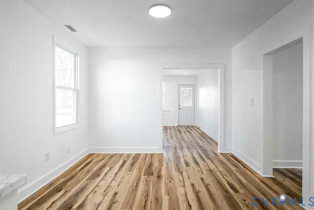 a view of a room with wooden floor and windows