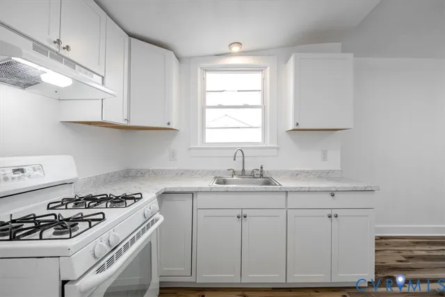 a kitchen with appliances cabinets and a sink
