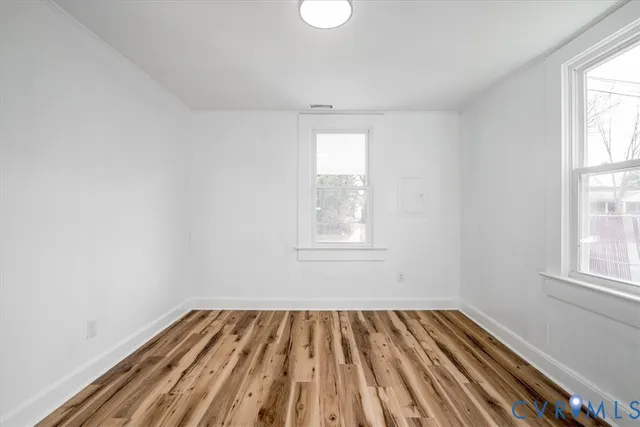 wooden floor in an empty room with a window