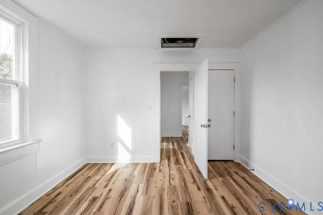 wooden floor in an empty room with a window