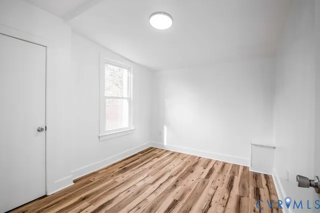 a view of a room with wooden floor and bedroom