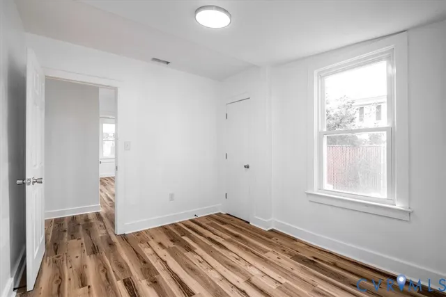 a view of room with window and hardwood floor