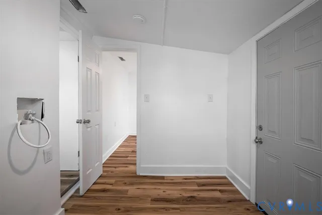 a view of room with wooden floor