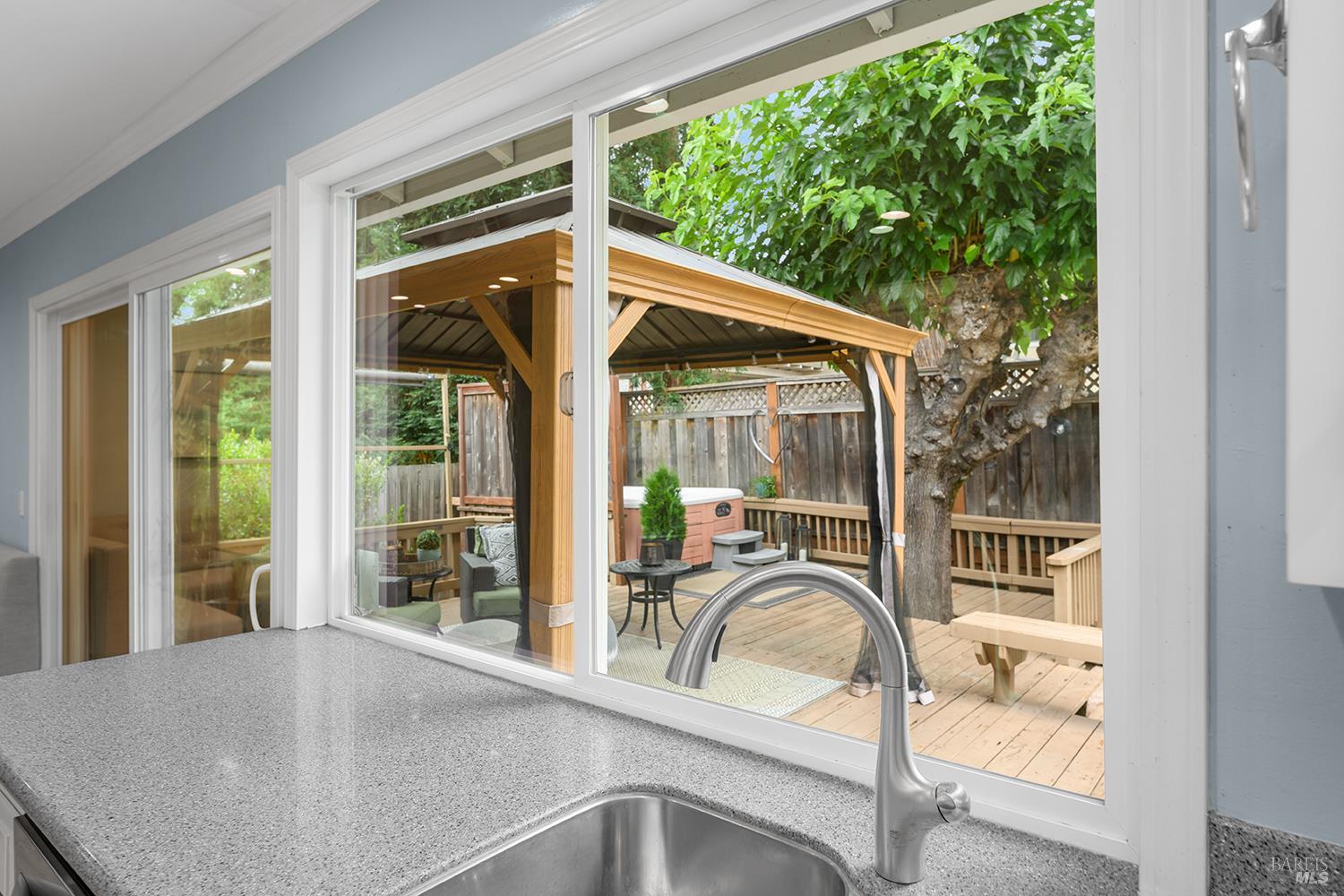 5313 Yerba Buena Road Santa Rosa, CA 95409 - Photo 11 of 34 Enjoy peaceful backyard views from the kitchen sink while overlooking the covered deck, mature landscaping, and private outdoor living spaces.