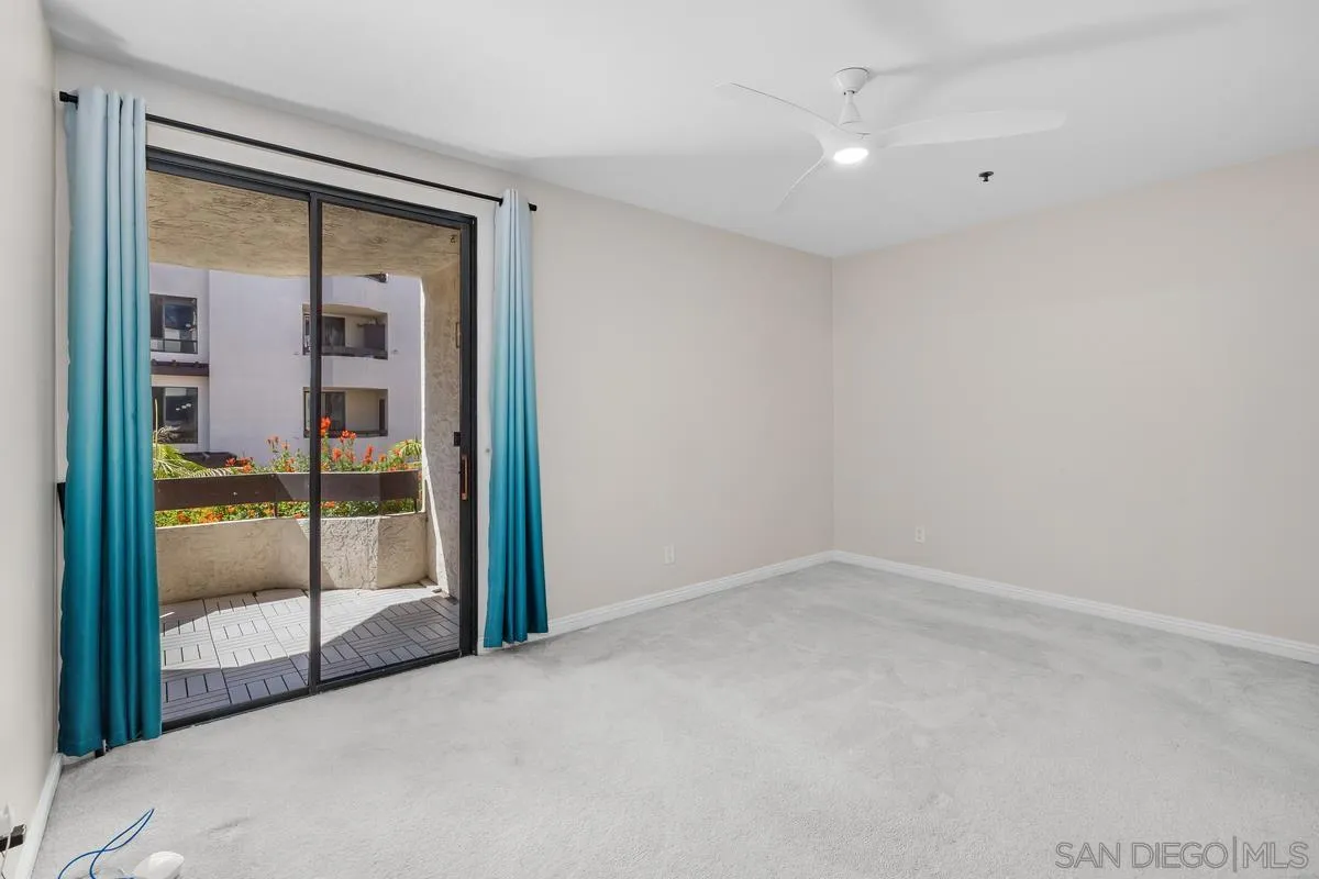 5845 Friars Road, Unit 1201 San Diego, CA 92110 - Photo 11 of 43 a view of an empty room with glass door