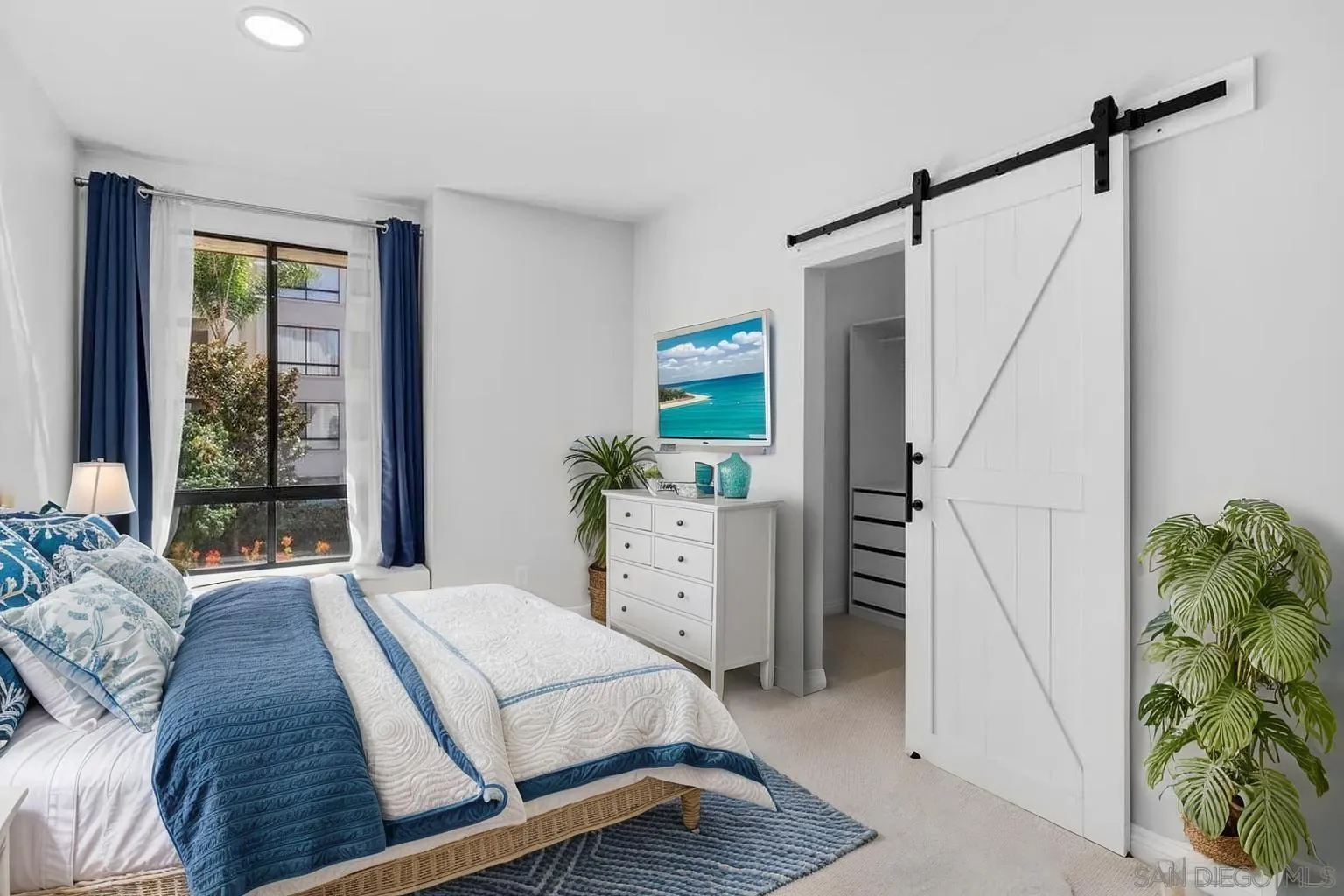 5845 Friars Road, Unit 1201 San Diego, CA 92110 - Photo 16 of 43 a bedroom with a bed and a window