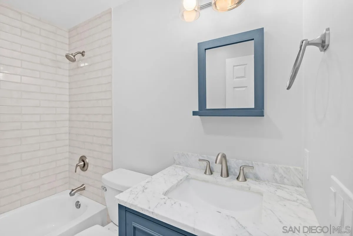 5845 Friars Road, Unit 1201 San Diego, CA 92110 - Photo 18 of 43 a bathroom with a granite countertop sink vanity tub and shower