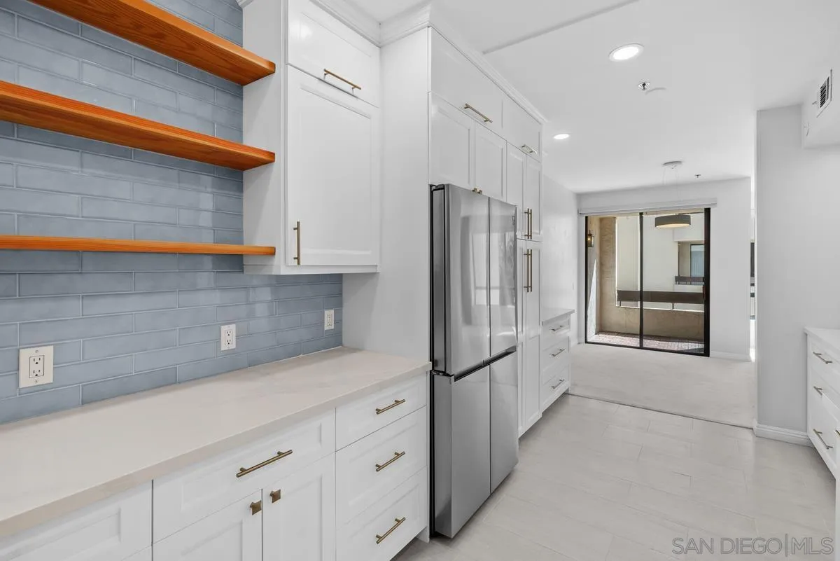 5845 Friars Road, Unit 1201 San Diego, CA 92110 - Photo 30 of 43 a kitchen with white cabinets and refrigerator
