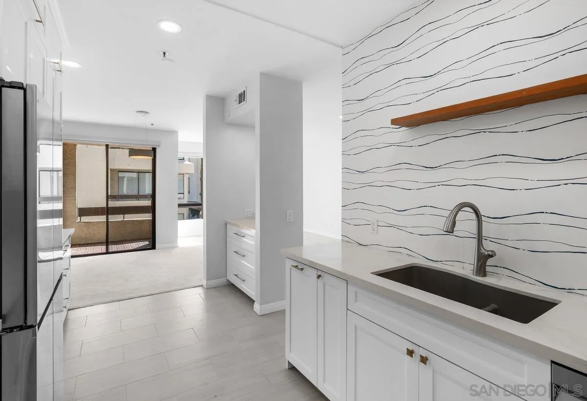 5845 Friars Road, Unit 1201 San Diego, CA 92110 - Photo 33 of 43 a kitchen with stainless steel appliances a refrigerator and a sink