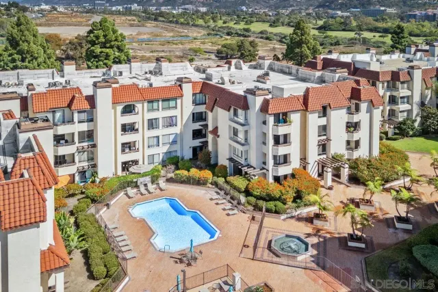a view of a tennis ground with large trees