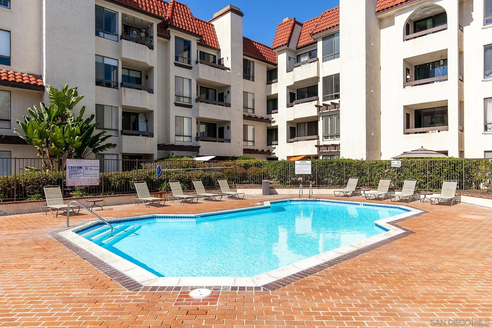 5845 Friars Road, Unit 1201 San Diego, CA 92110 - Photo 42 of 43 a view of a swimming pool with a lounge chairs