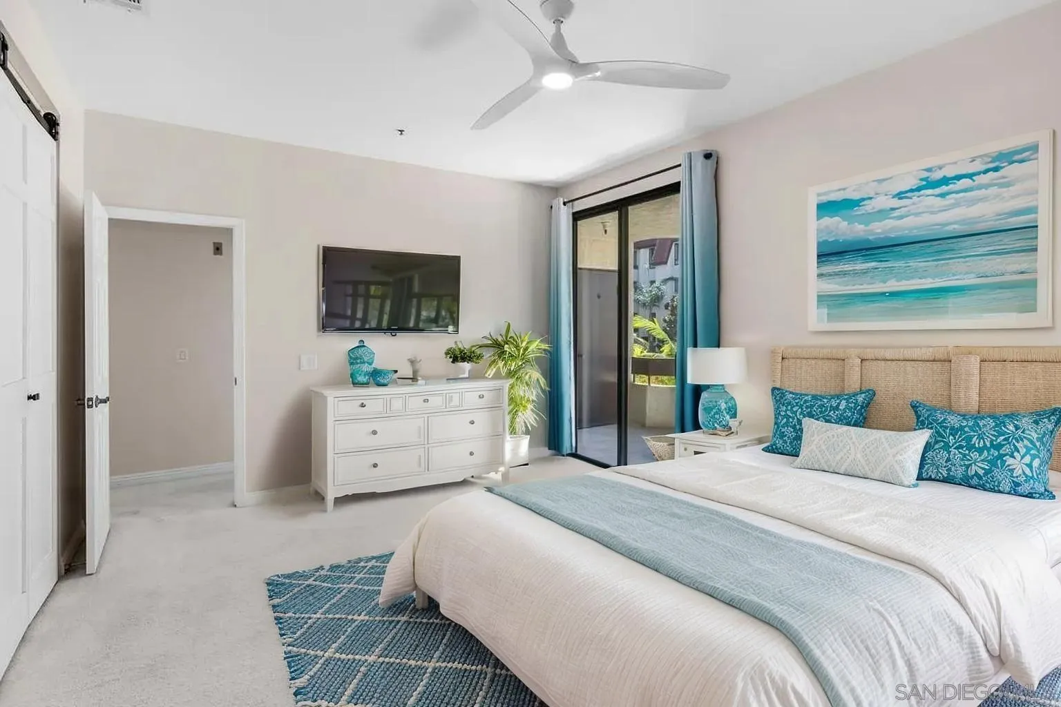 5845 Friars Road, Unit 1201 San Diego, CA 92110 - Photo 9 of 43 a bedroom with a large bed and a flat screen tv