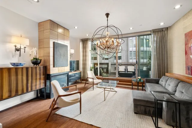 a living room with furniture and a chandelier