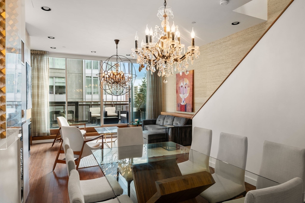 88 Kingston Street, Unit PH7C Boston, MA 02111 - Photo 11 of 31 a view of a dining room with furniture a chandelier and wooden floor