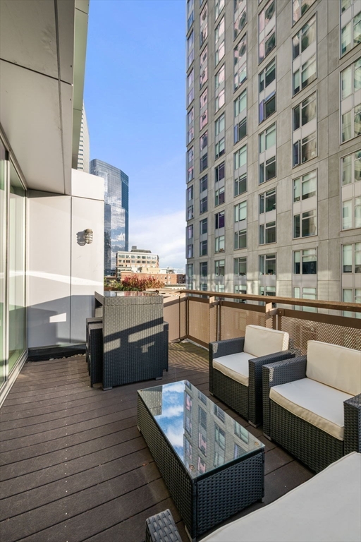 88 Kingston Street, Unit PH7C Boston, MA 02111 - Photo 14 of 31 a living room with furniture and wooden floor